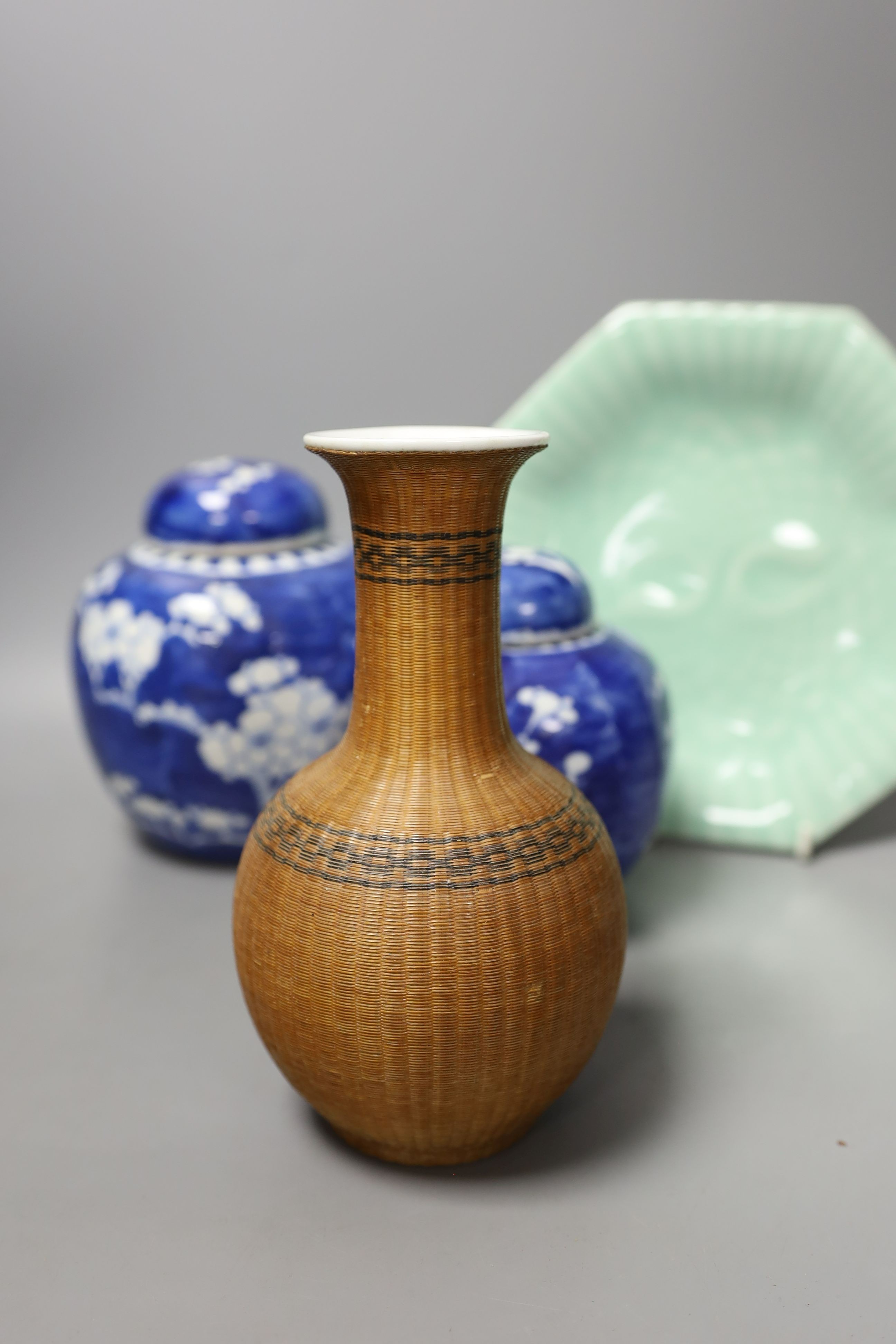 Three Chinese blue and white ginger jars and covers, a celadon plate and bamboo covered vase (5)